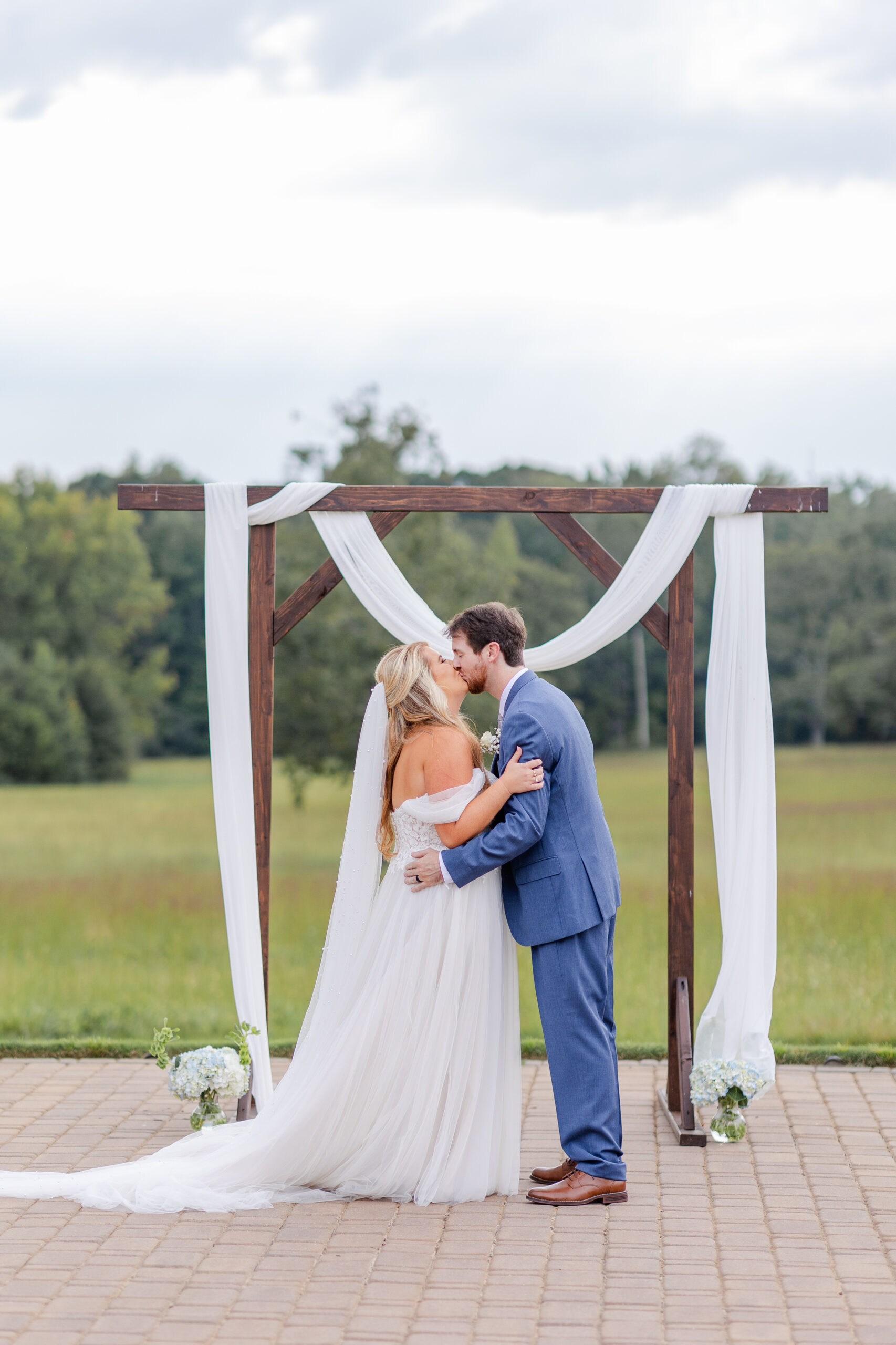 groom and bride kissing at wedding ceremony at sitton hill