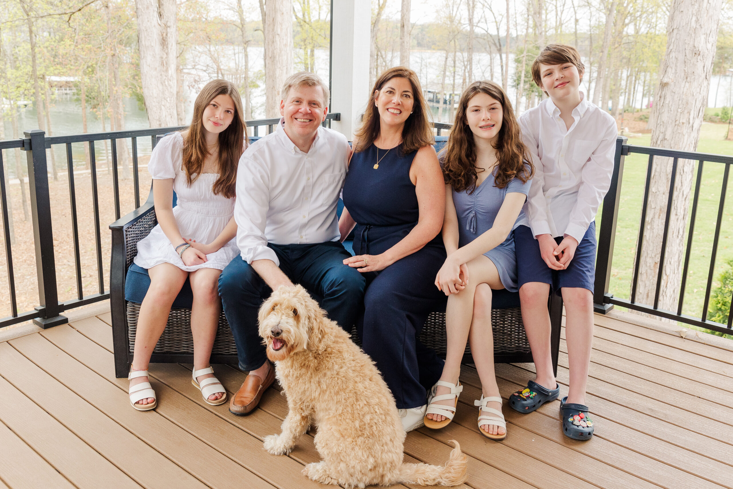 family sitting on a couch on their lake hartwell home