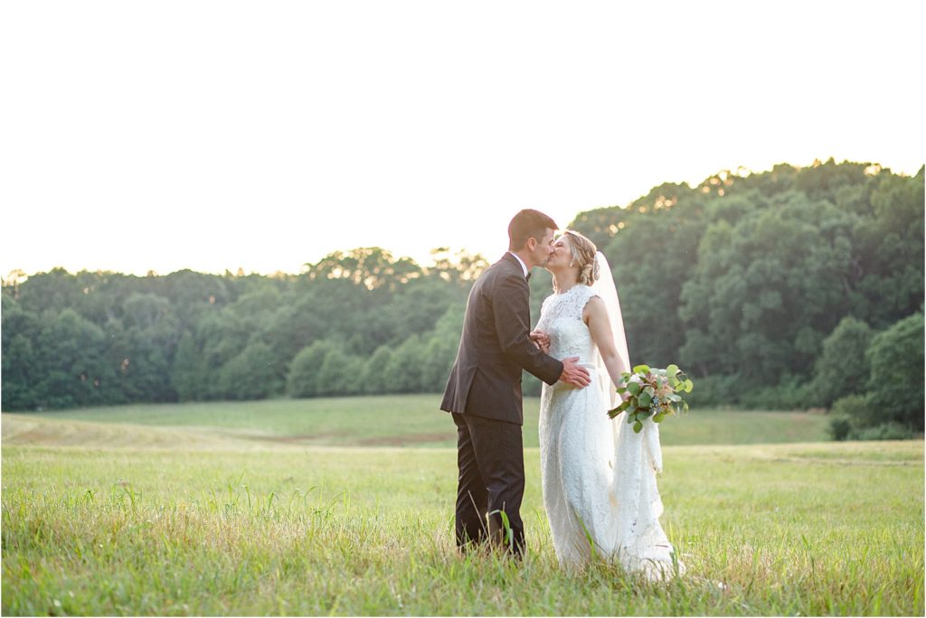 Bride and Groom in a field kissing in Anderson, SC
