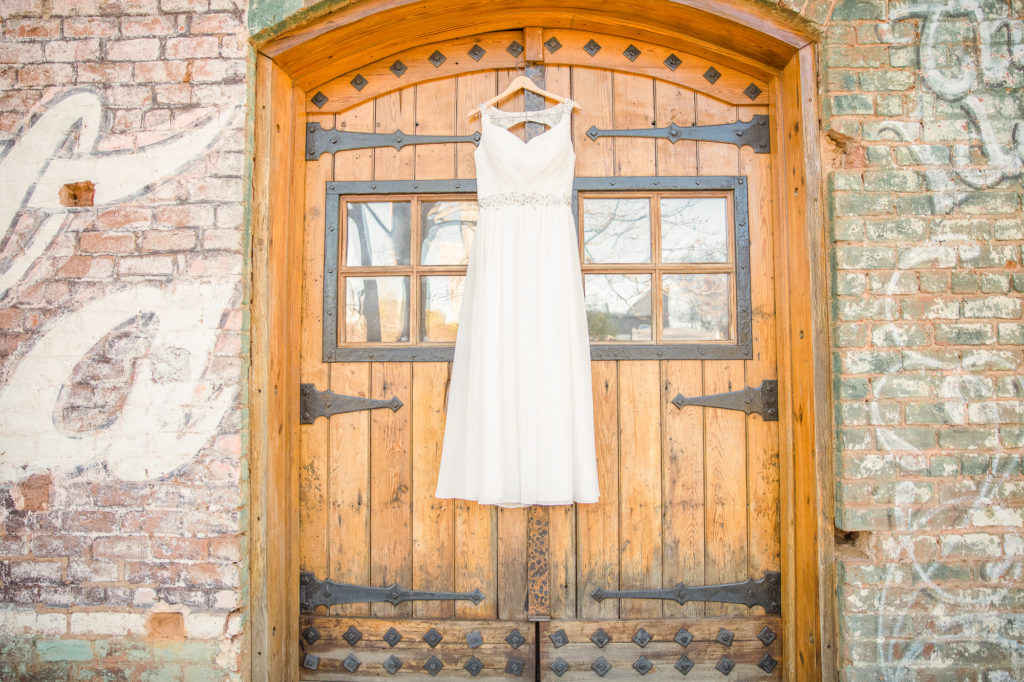 Wedding dress hanging on Old Cigar Warehouse door