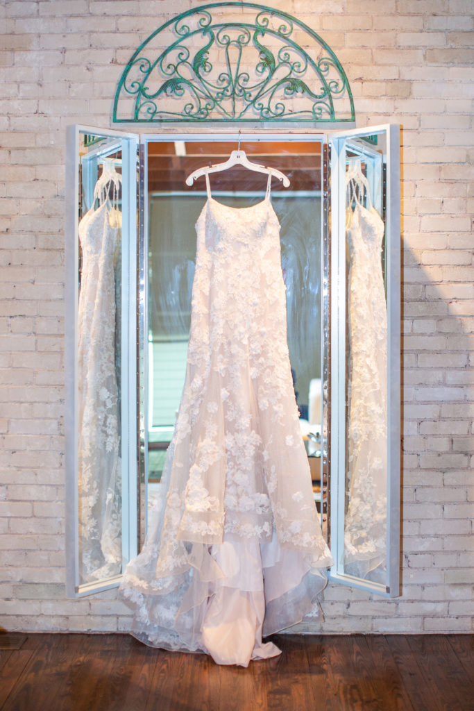 Wedding dress hanging on a mirror in Zen event space