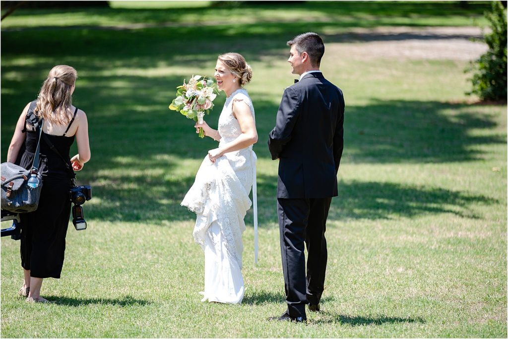 bride and groom talking to wedding photographer after ceremony