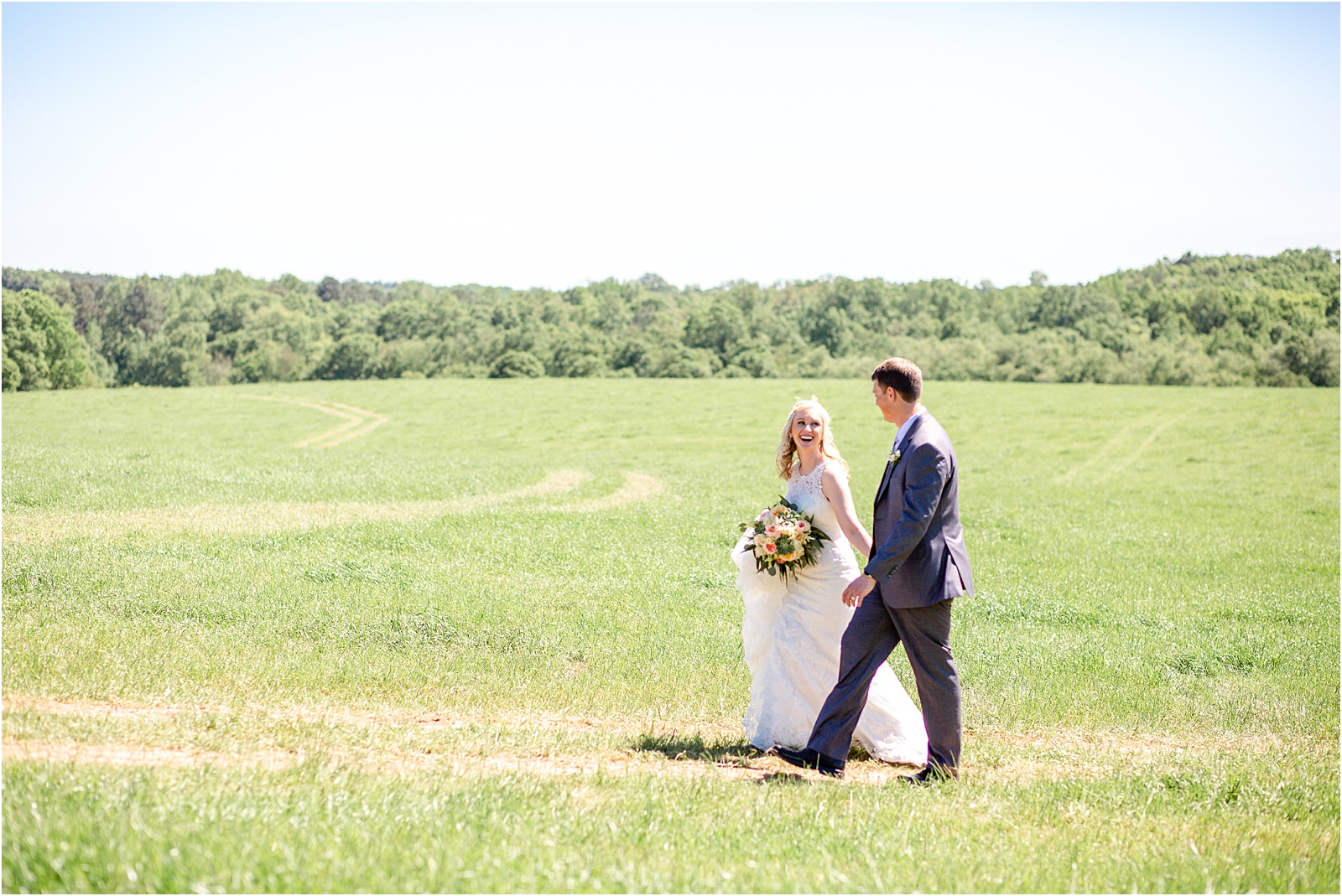 Wedding couple walking through field