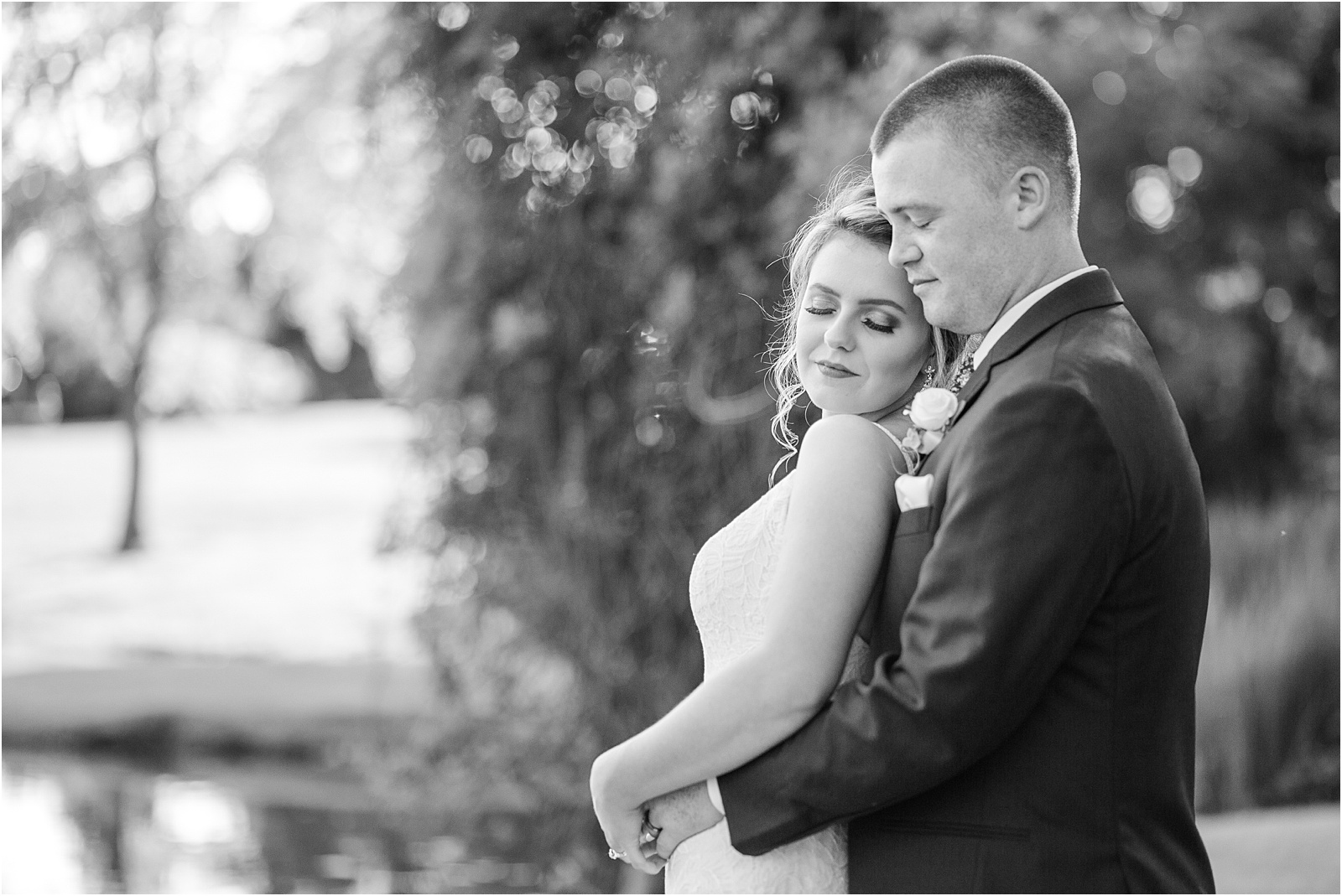 Married couple hugging with eyes closed for wedding photographer
