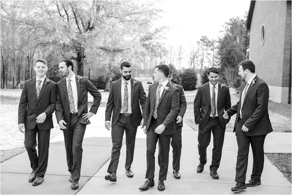 men walk in suits before wedding