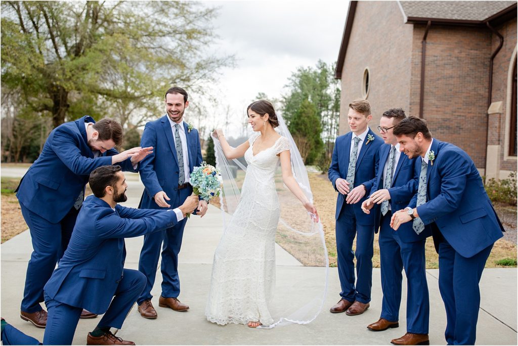 Bride laughs with groomsmen