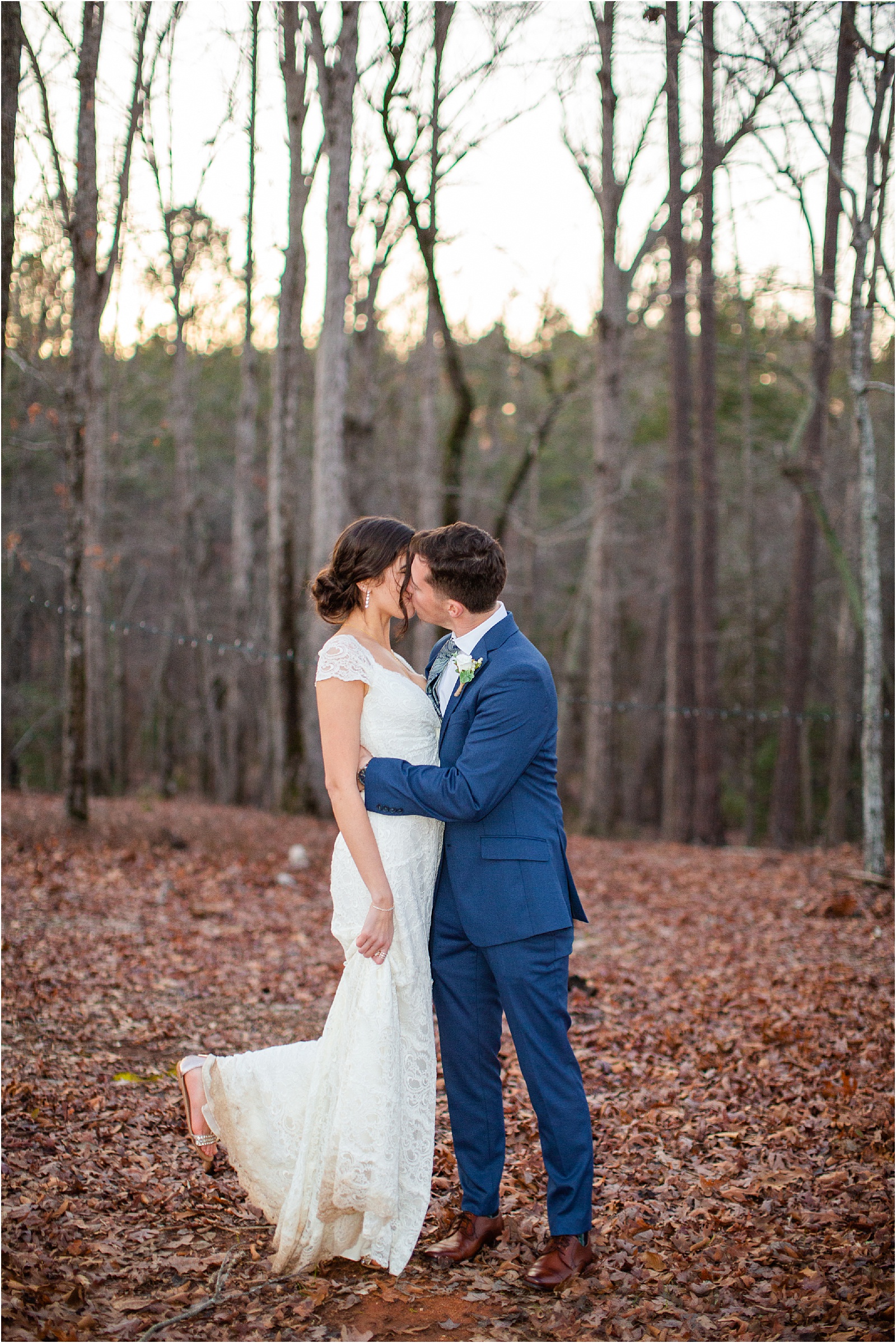 Newlyweds kiss in the woods