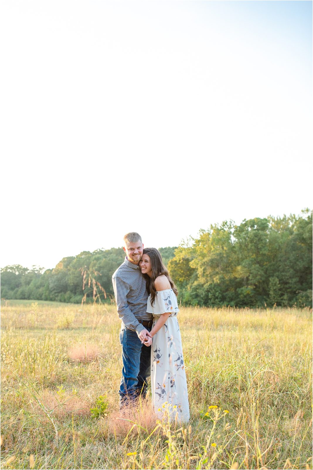 Guy and girl hugging in hay field