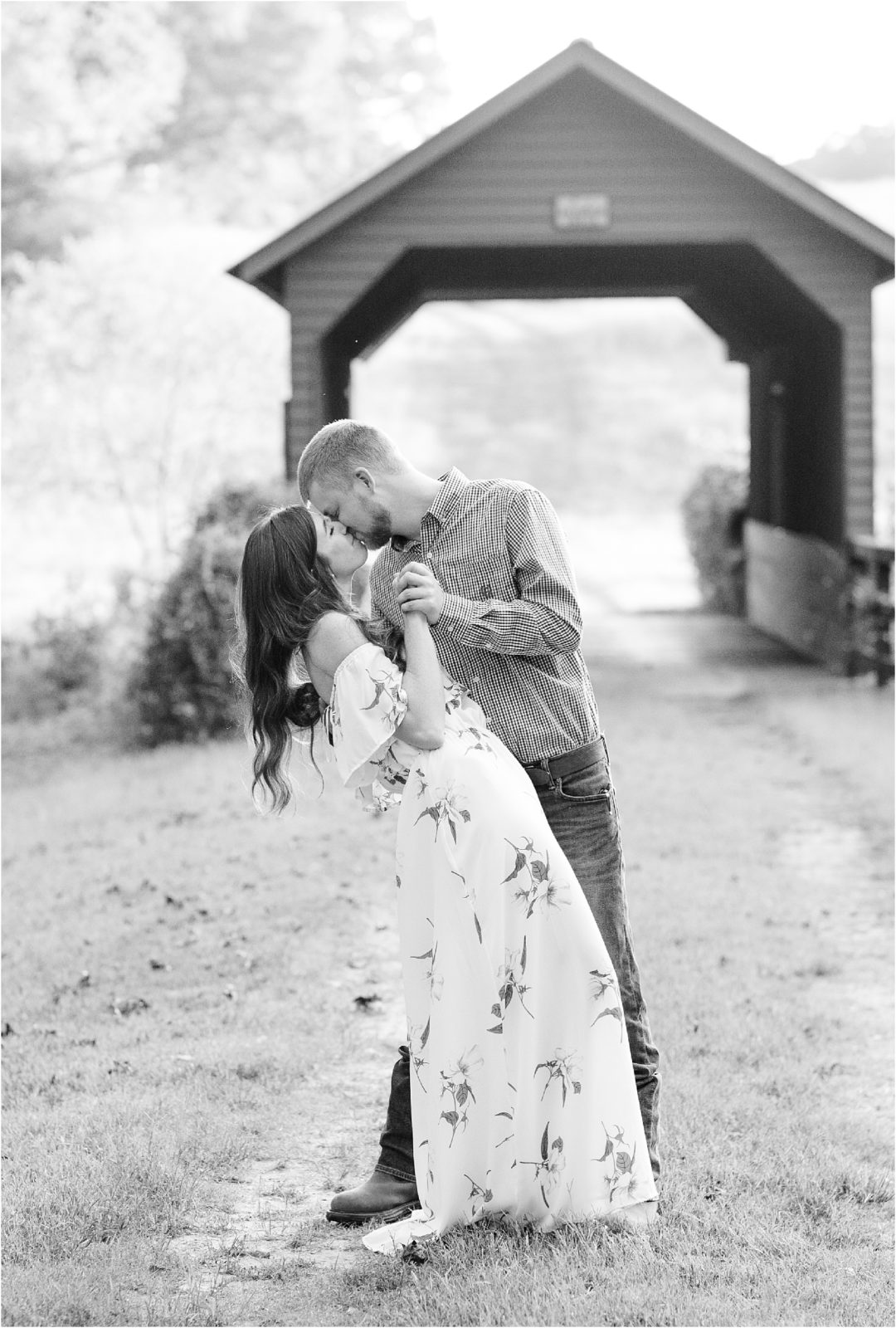 Woman and man kissing at covered bridge