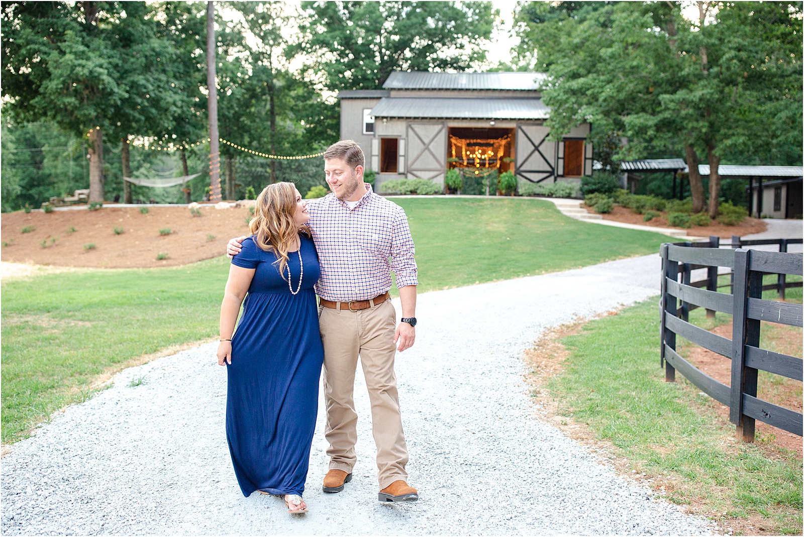 Couple walking in front of barn