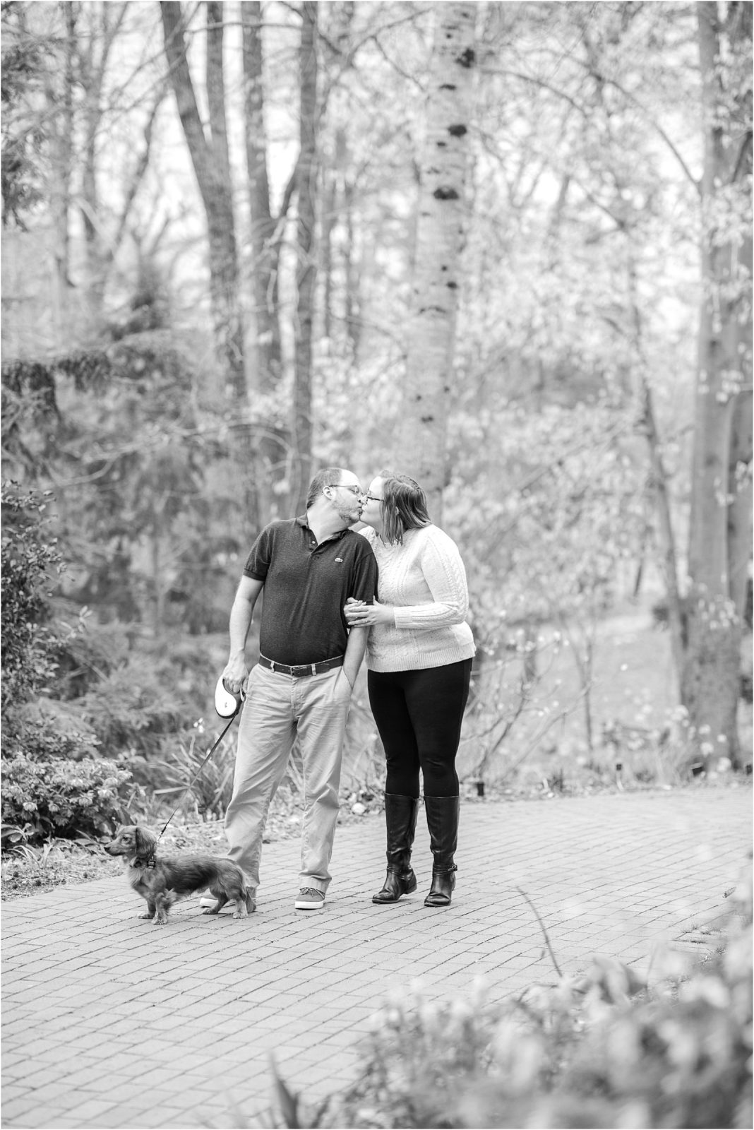 couple walking dog for engagement pictures
