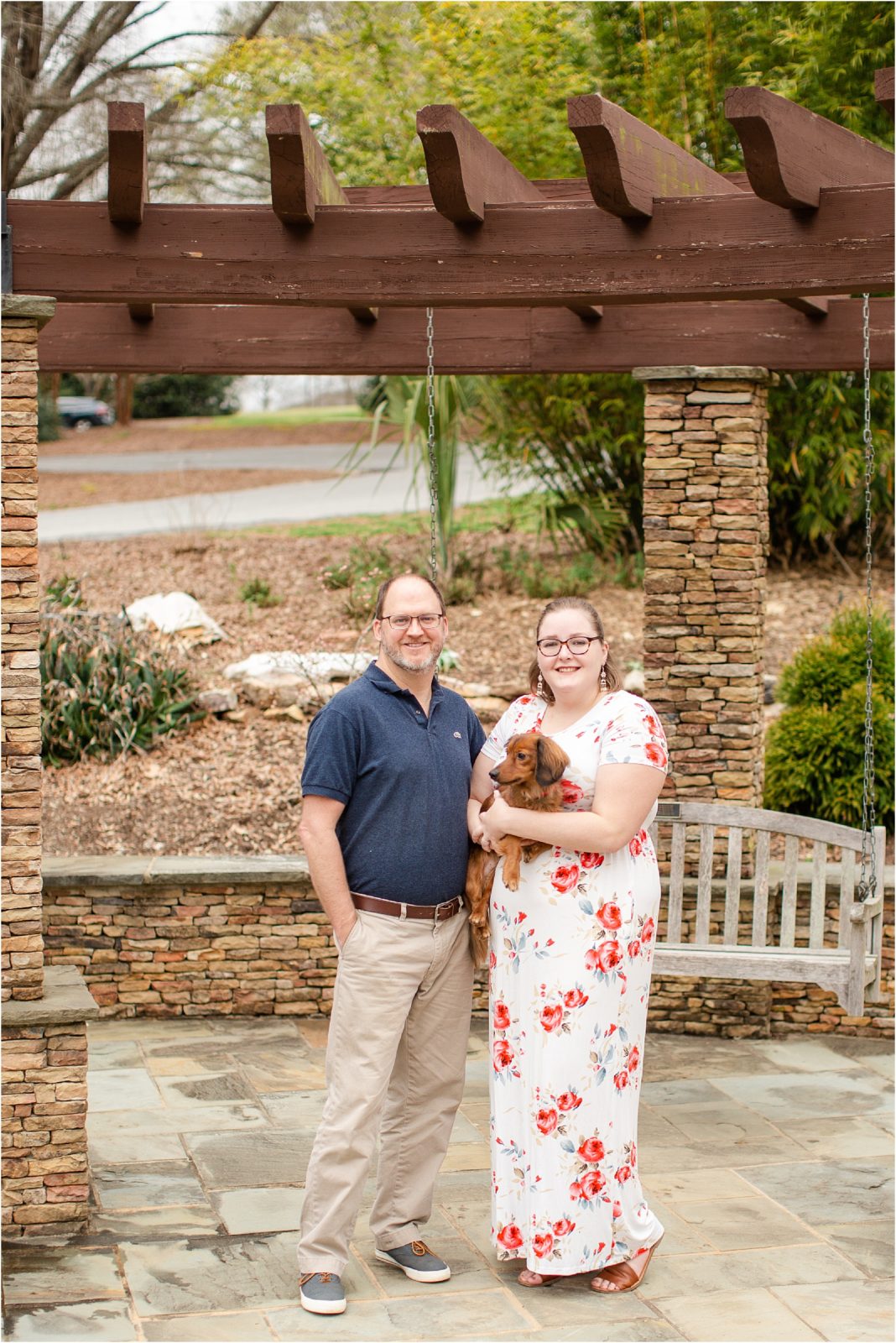 Couple holds dog during pictures