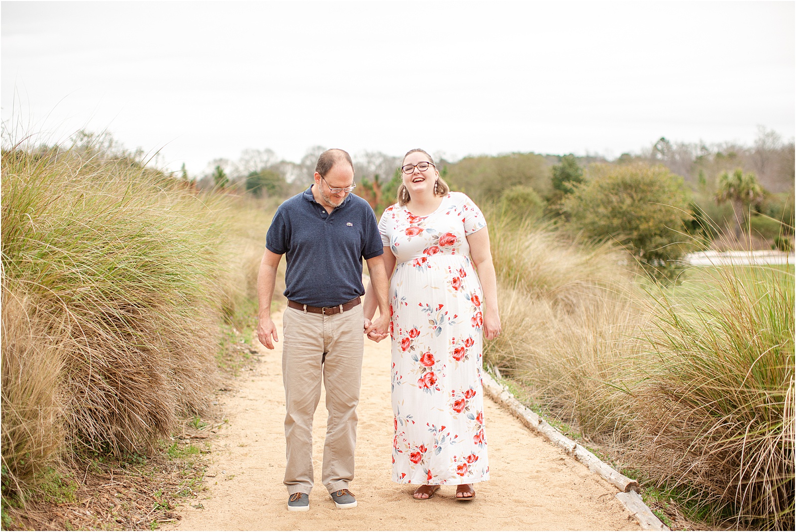 man and woman laugh walking through botanical gardens