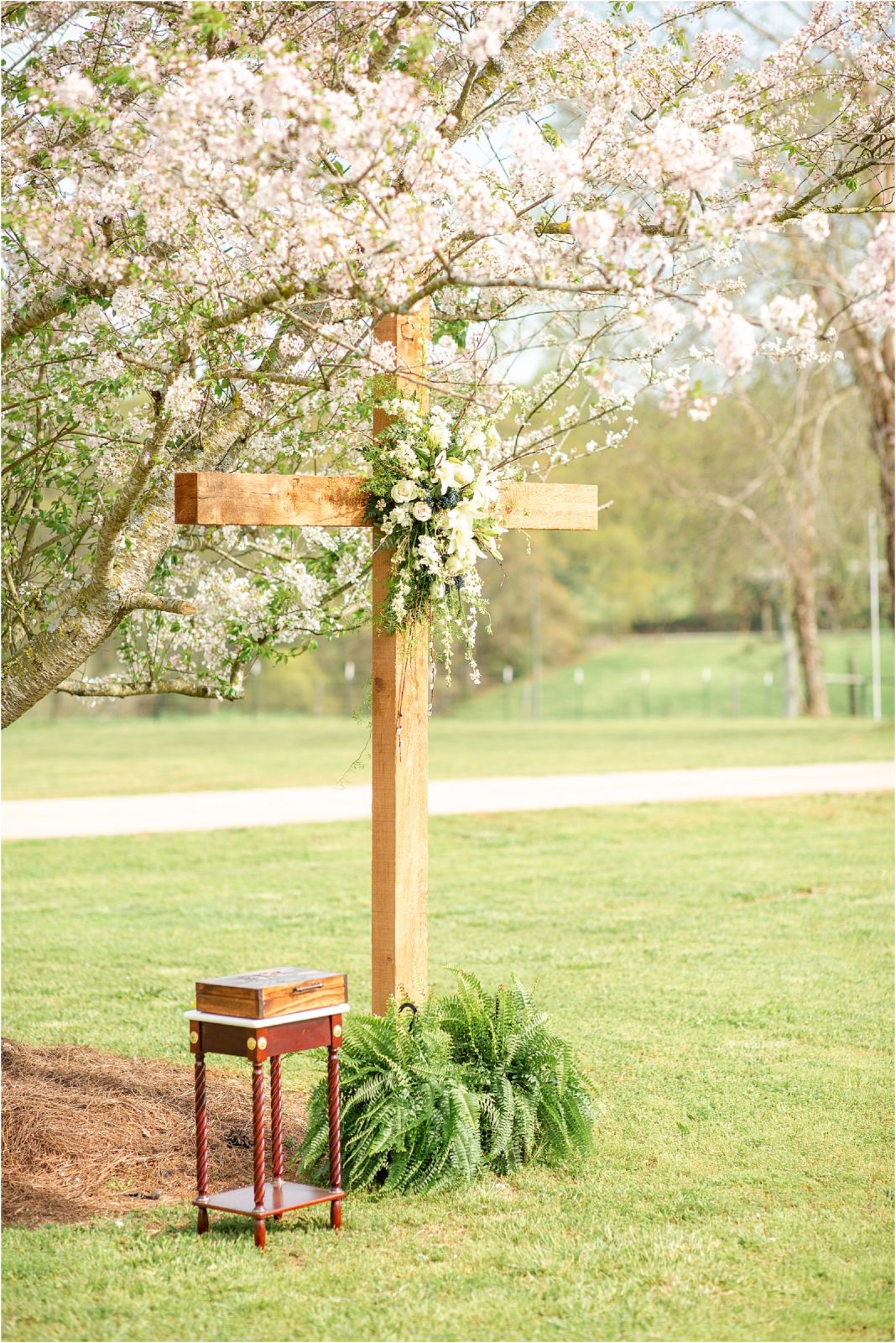 wooden cross at outdoor wedding