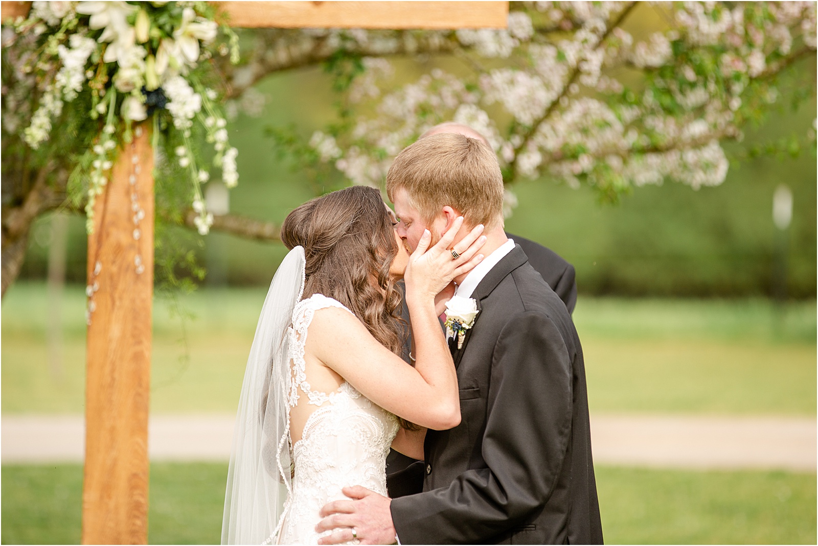 first kiss at intimate outdoor wedding