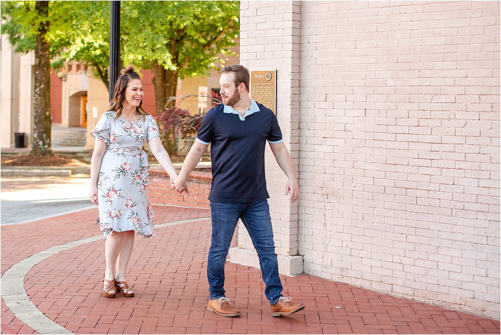 couple walking hand in hand for engagement session