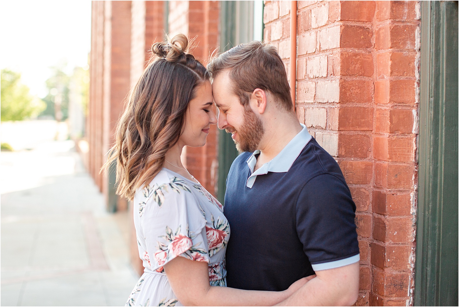 Engaged couple hugging in downtown Anderson