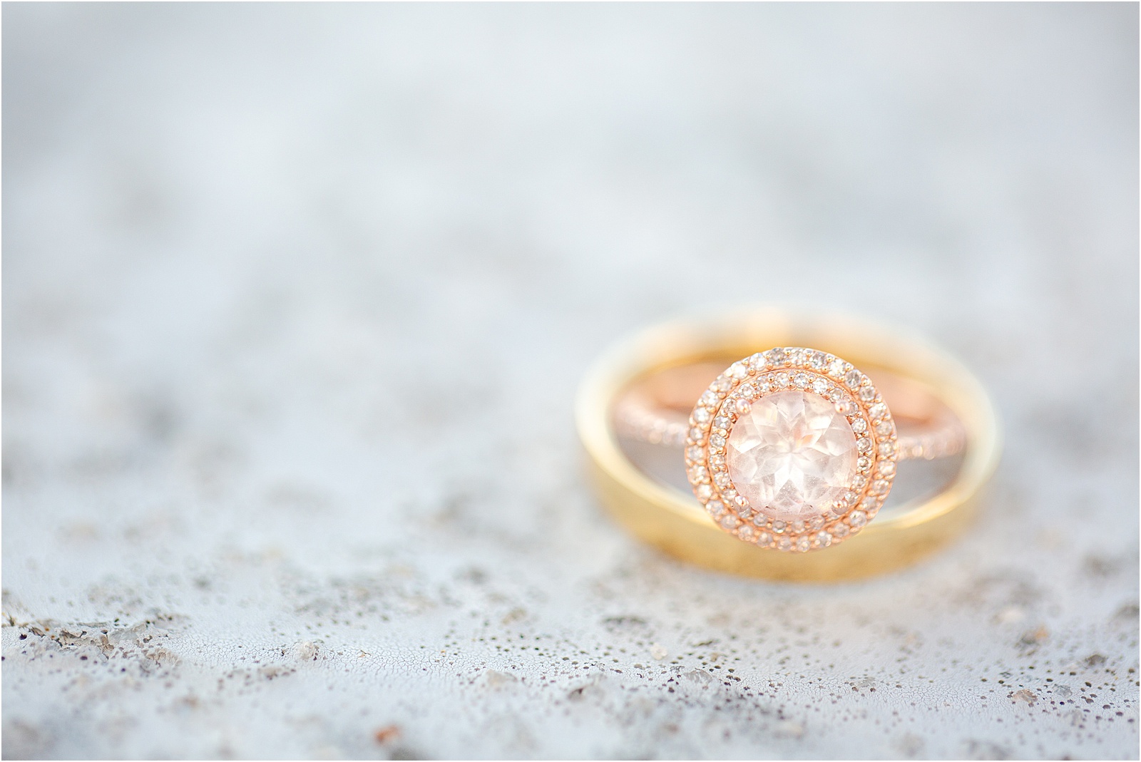 Yellow gold engagement ring and wedding ring on stone