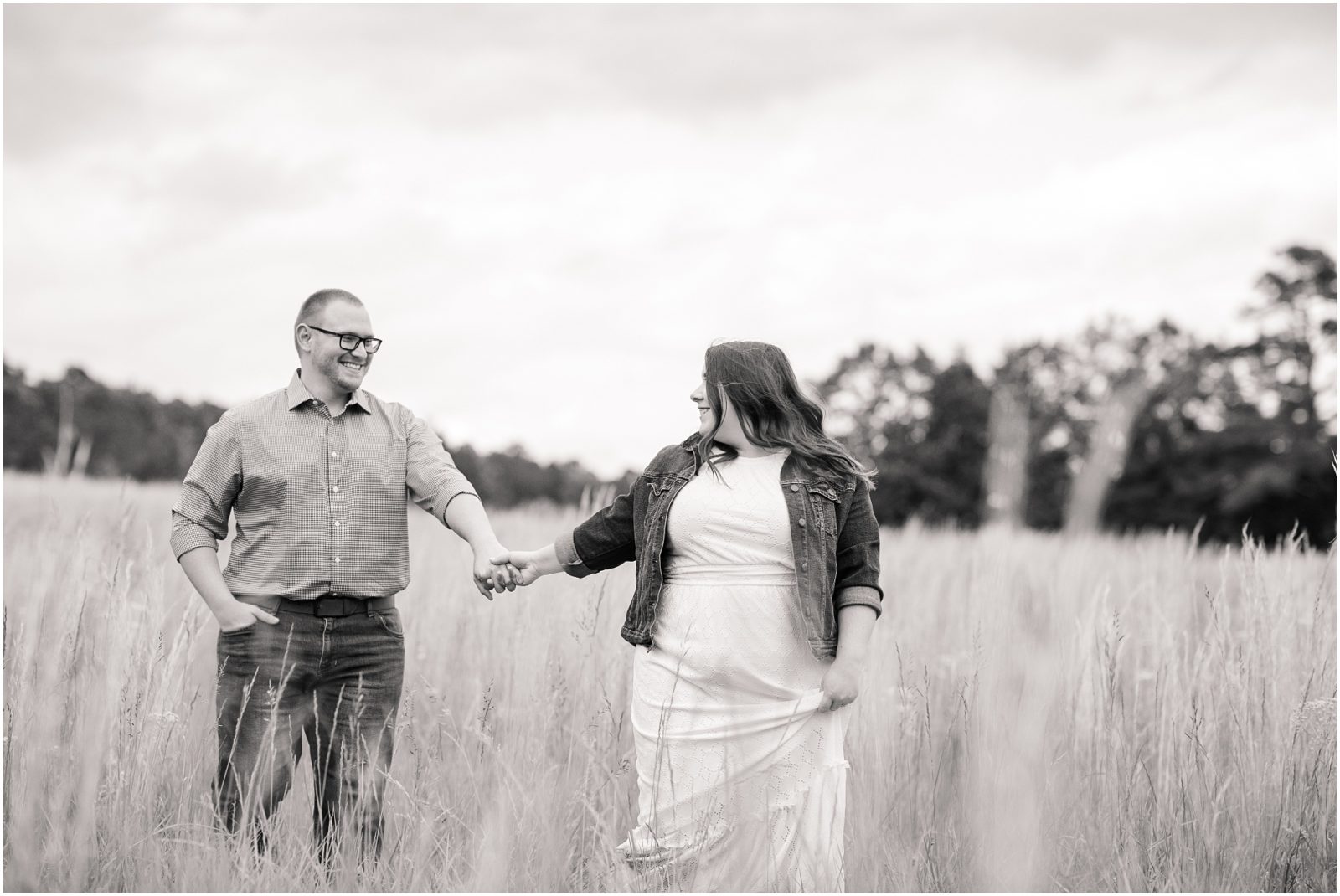 couple walking hand in hand in a field