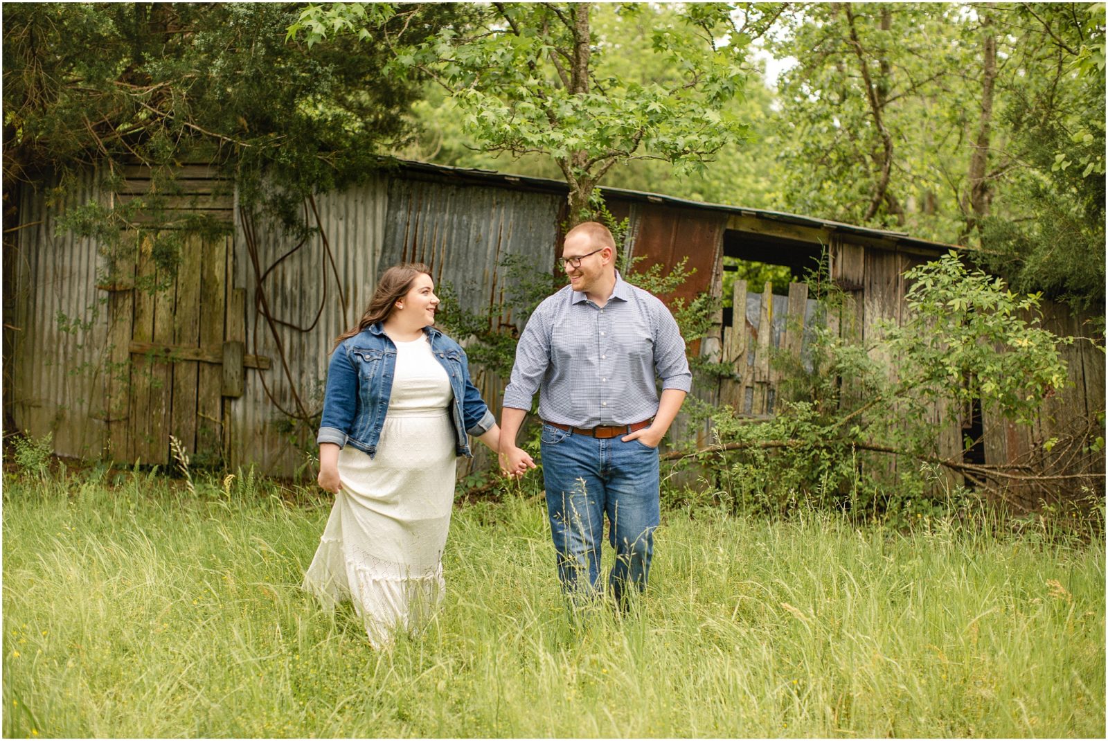rustic engagement session in a field next to a barn