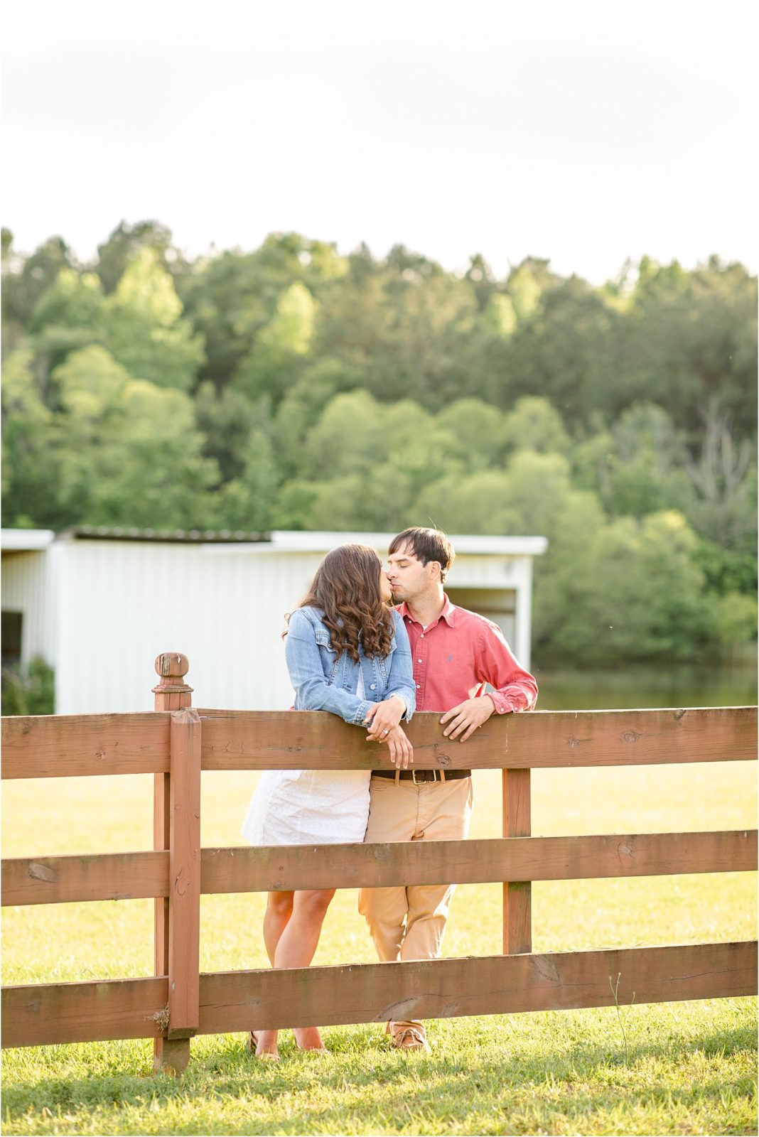 Kissing couple on a fence