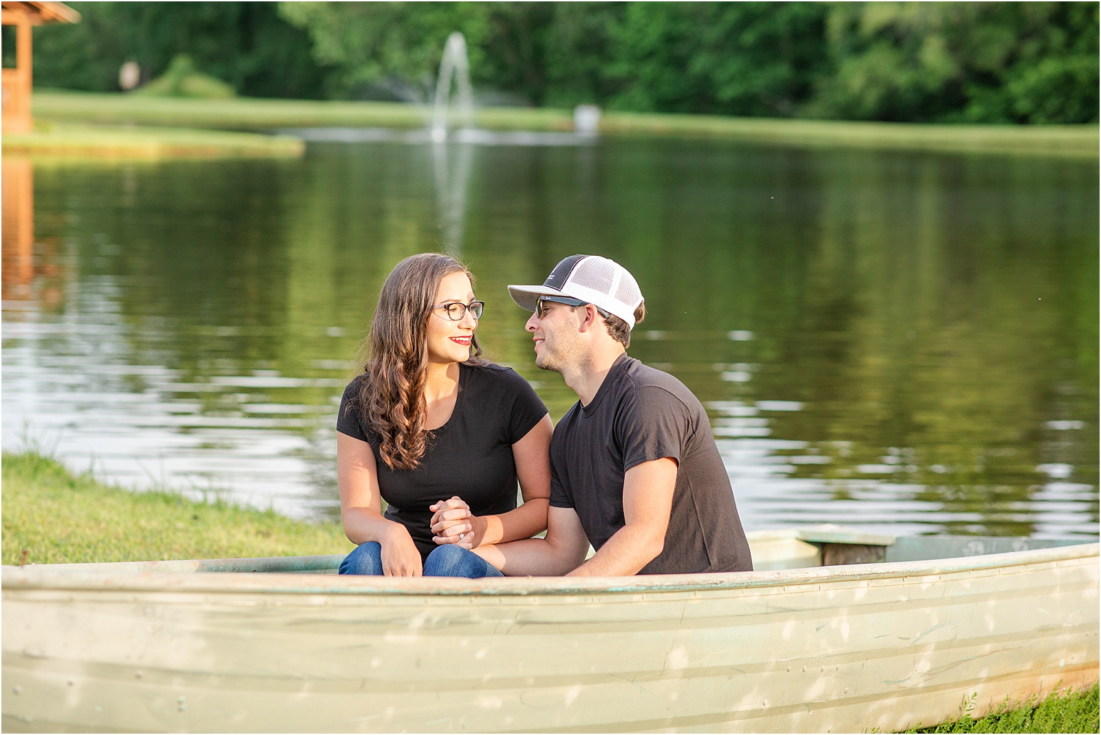 Couple posing in boat for photography session