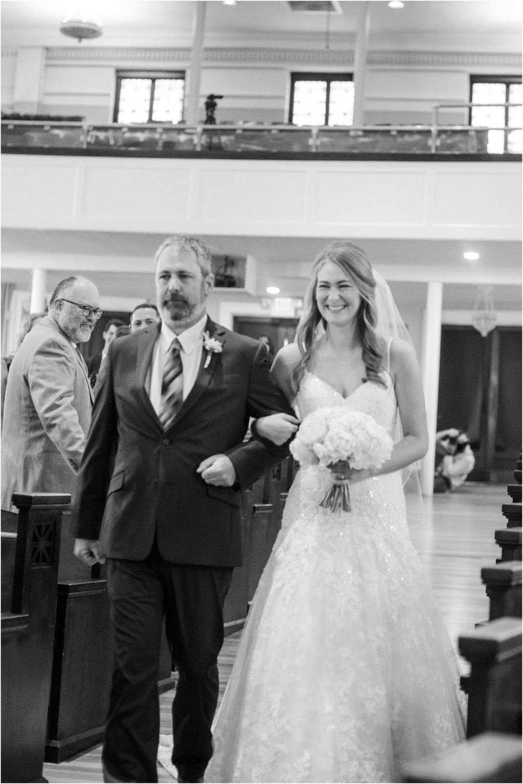 Bride walks with dad down church aisle