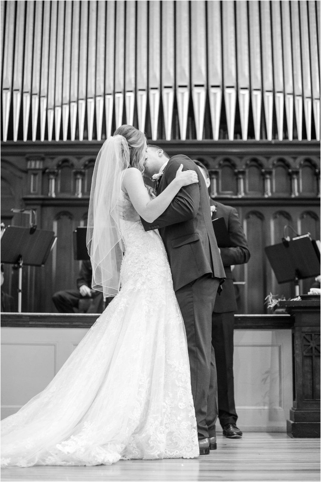 Couple kisses at wedding in church