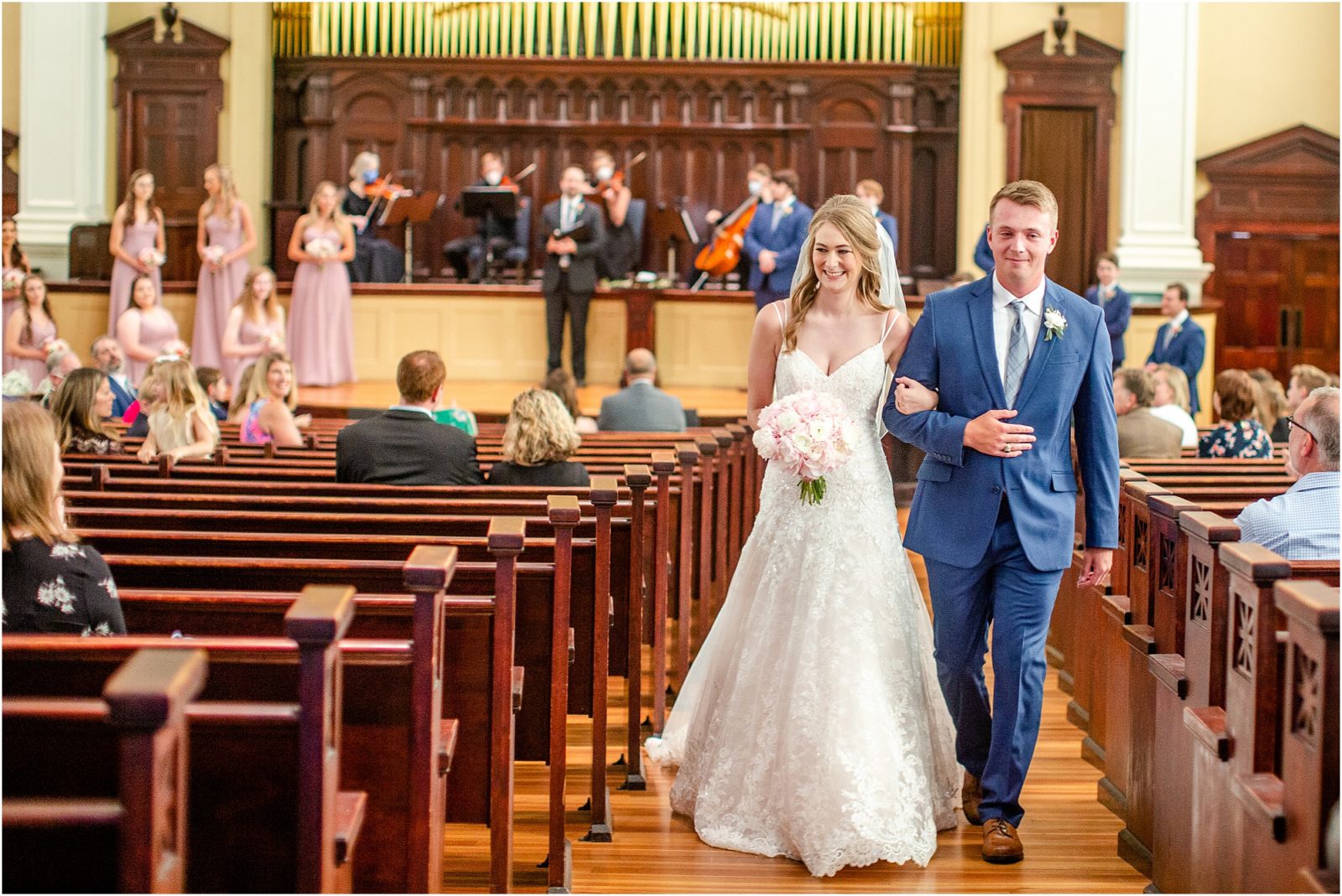 Groom and bride walking down church aisle