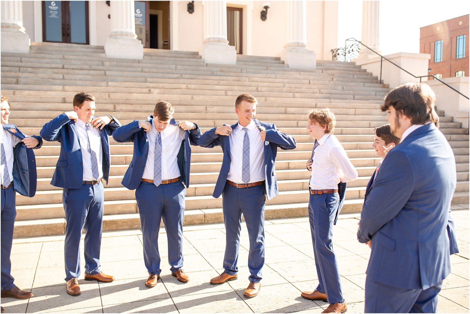 Groom and guys putting on jackets