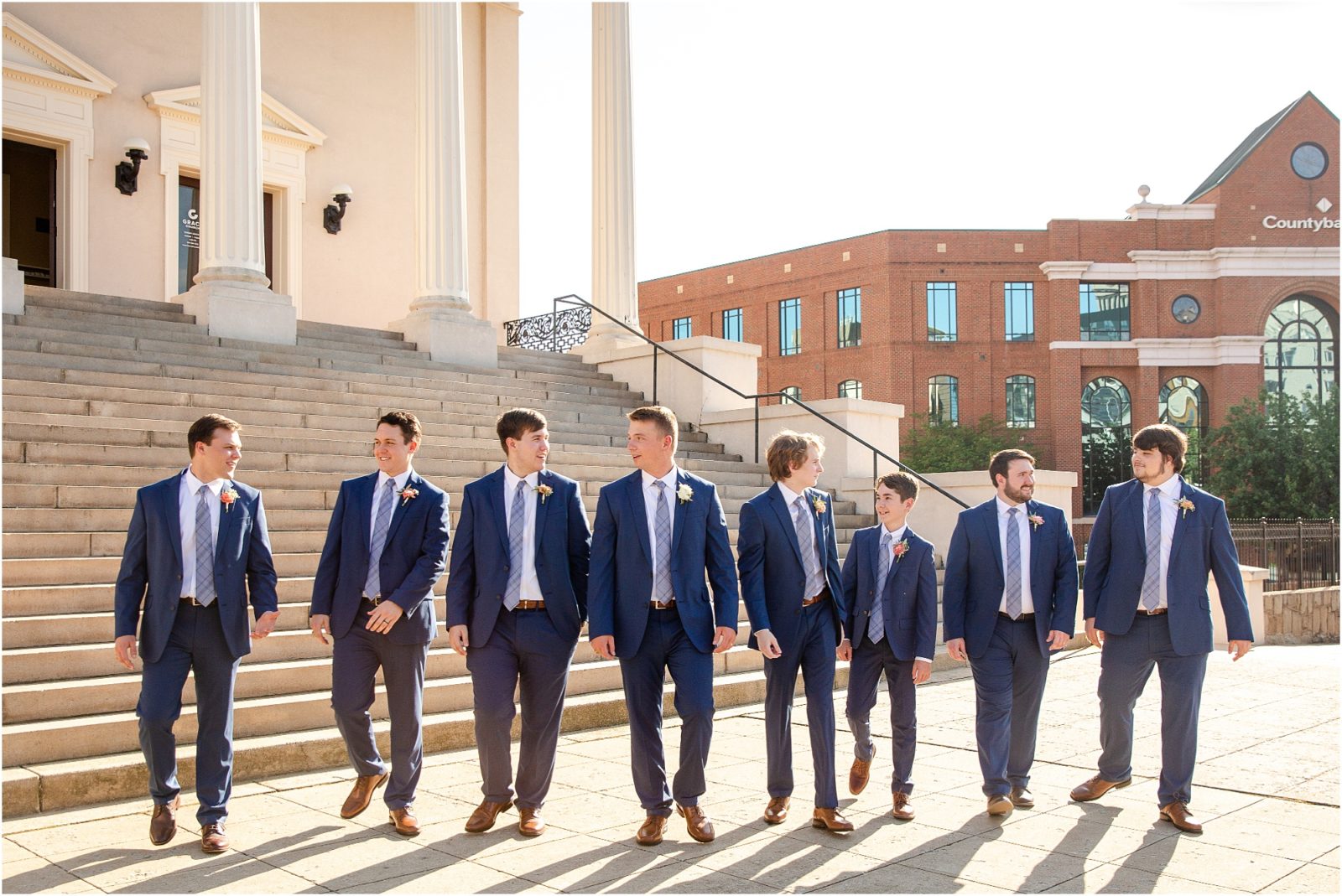Grooms with groomsmen in front of Greenville church