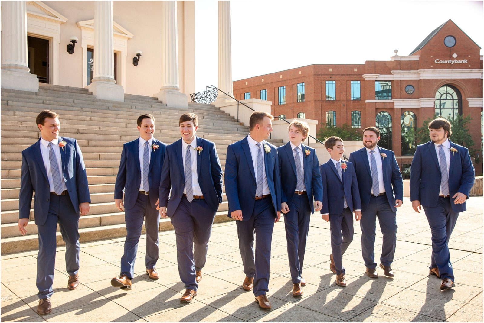 Groom with friends walking in front of Grace church in Greenville