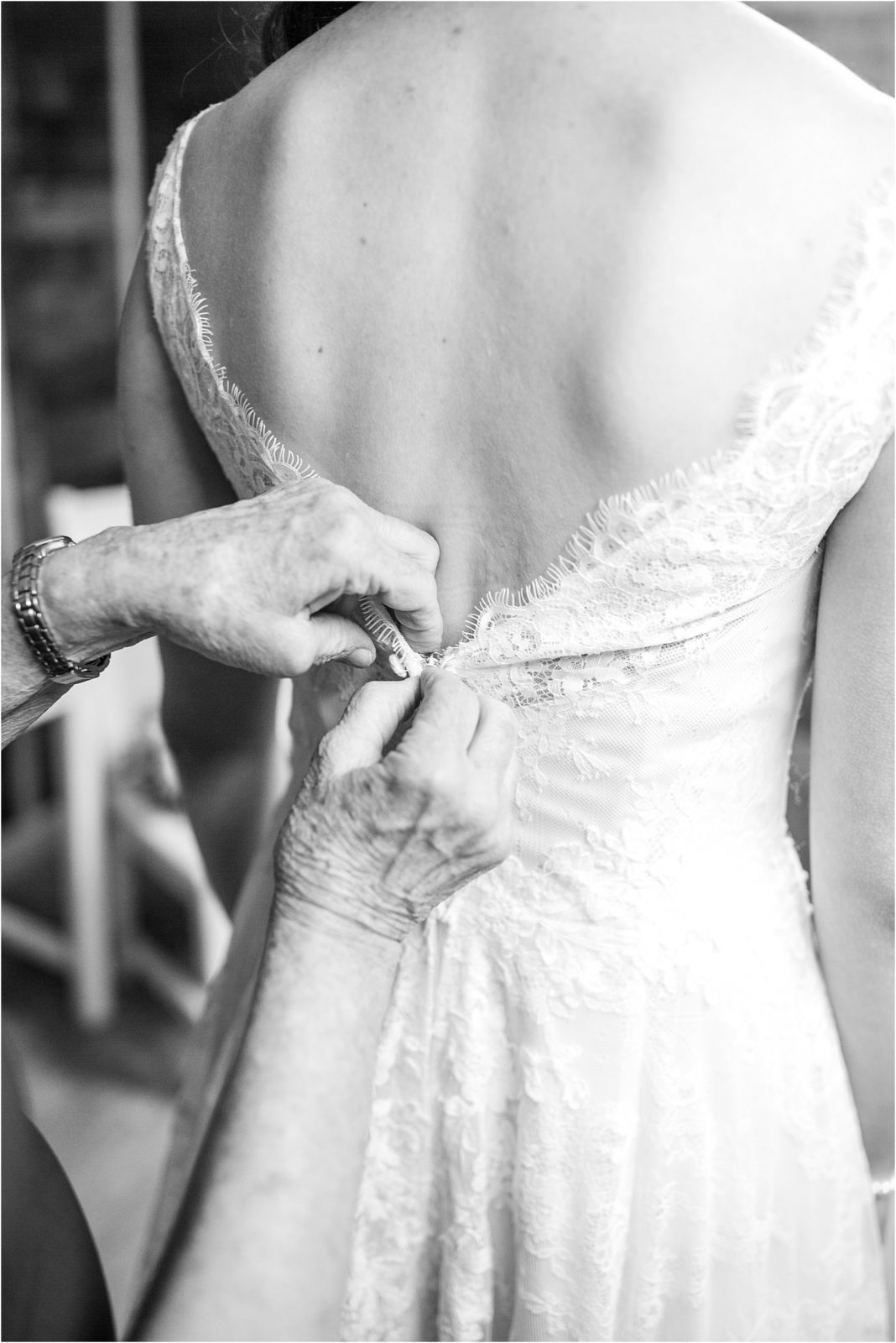 Woman putting on wedding dress