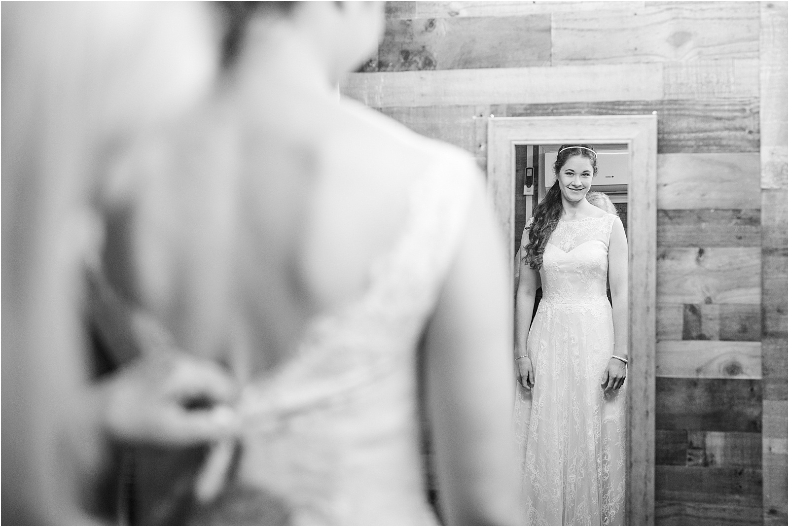 Bride looking in mirror before wedding