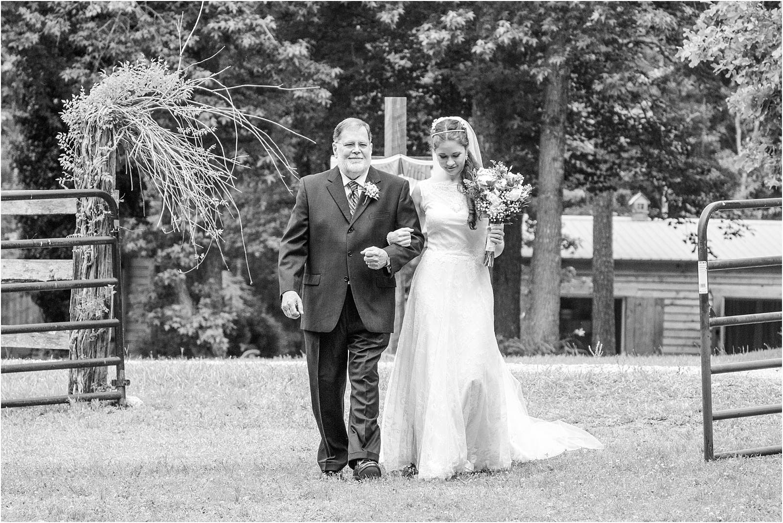 Bride walking with father down wedding aisle