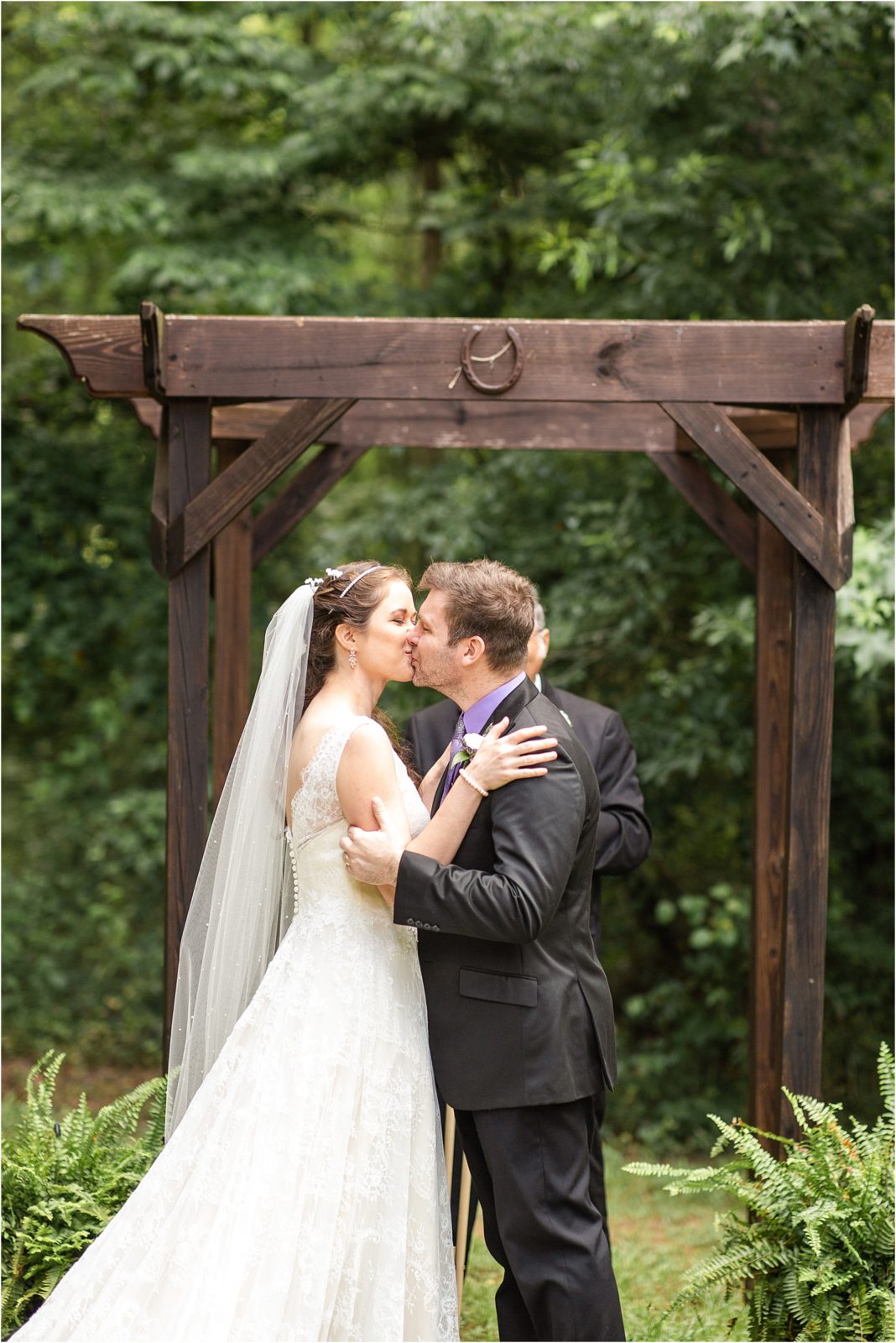 Kissing couple at woods ceremony
