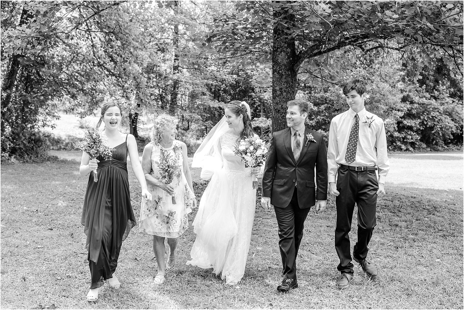 Groom and bride walking in woods with friends