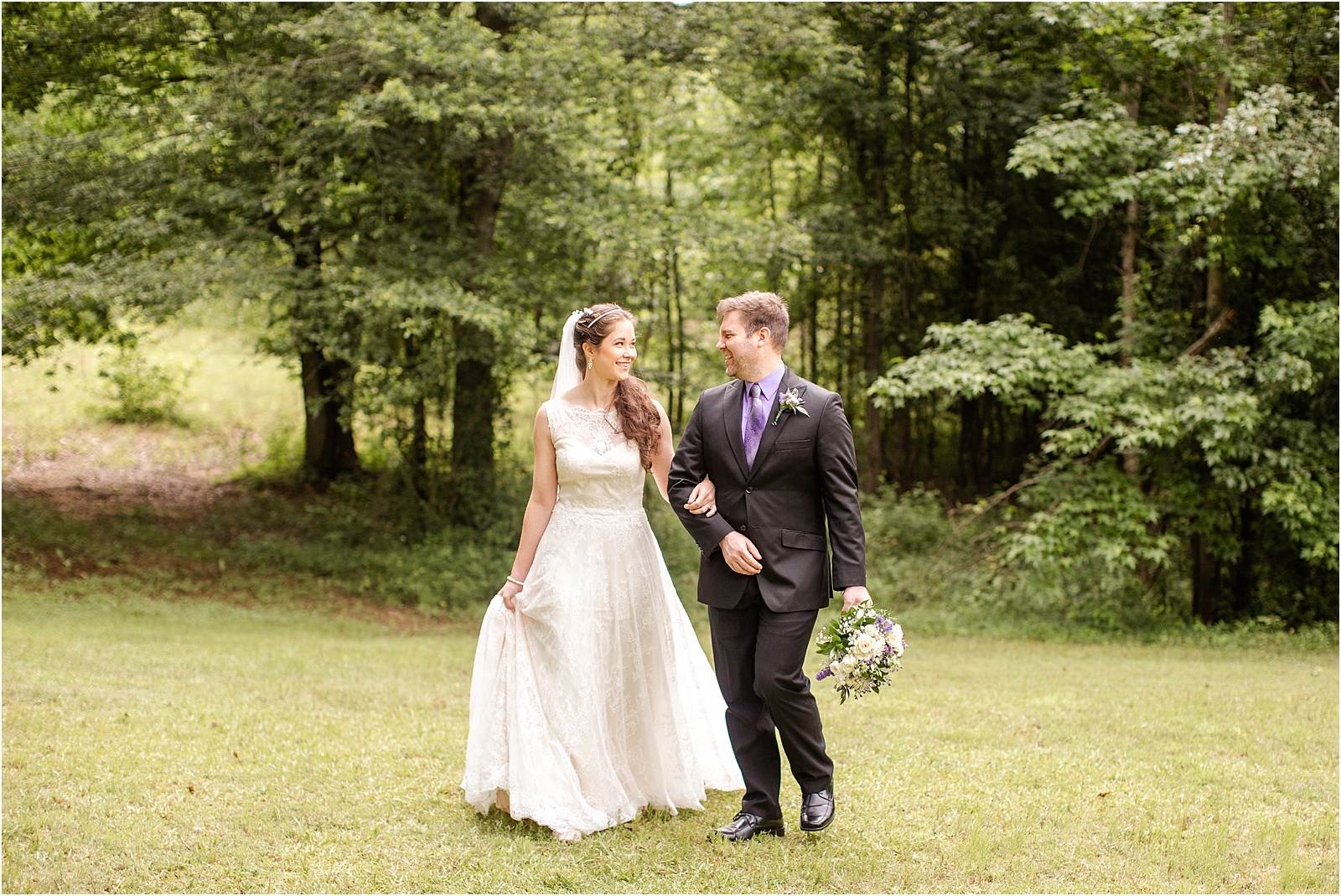 Couple walking in woods after wedding