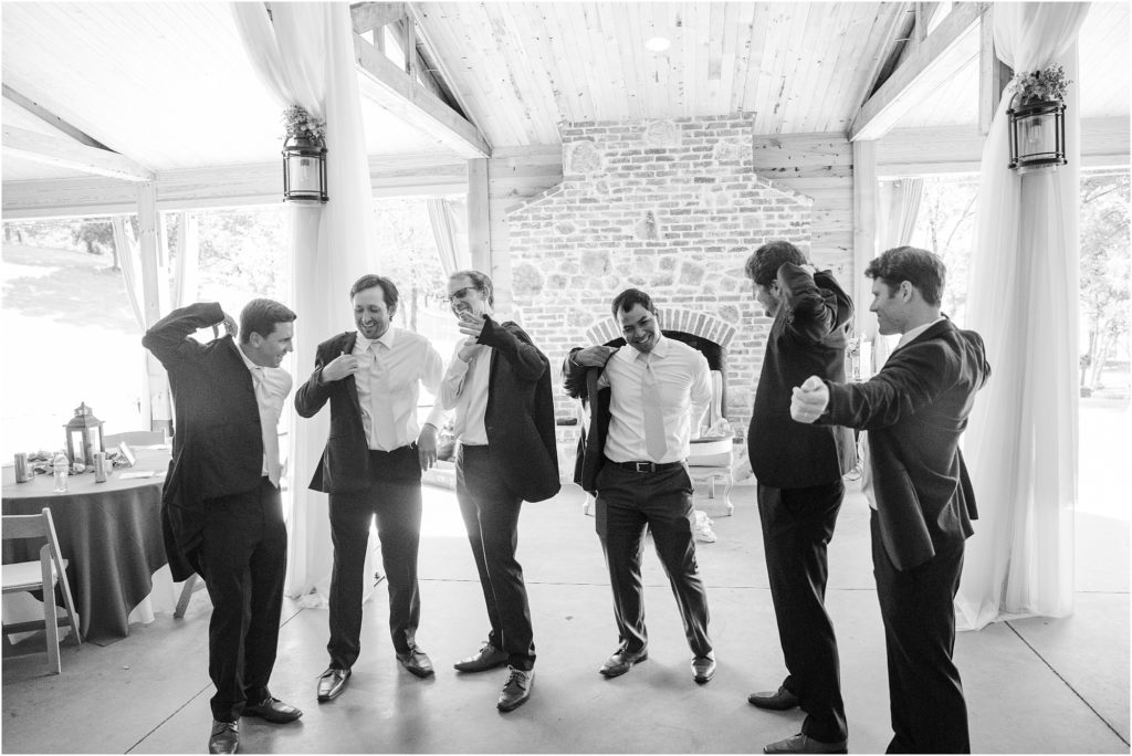 Groomsmen putting on jackets at South Wind Ranch