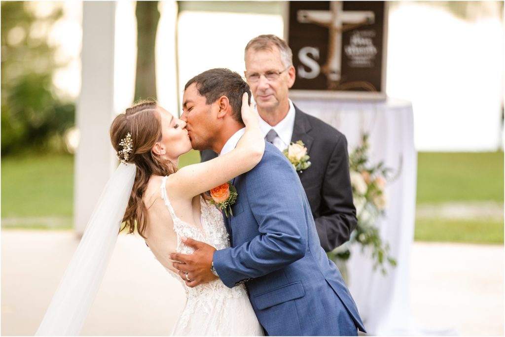 Bride and groom share first kiss as married couple
