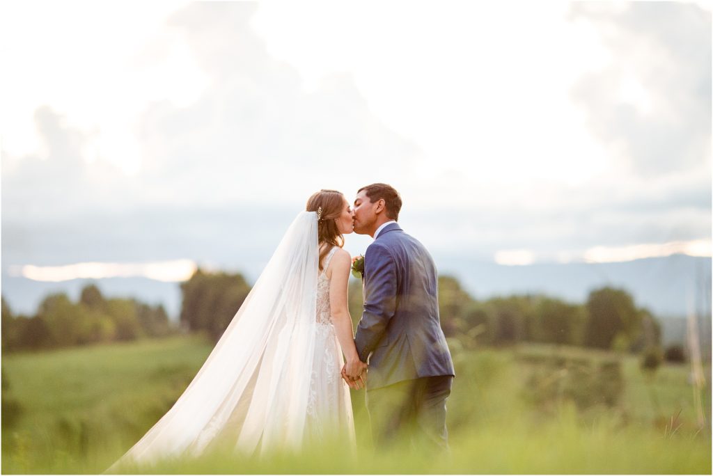 Wedding couple kissing in mountains