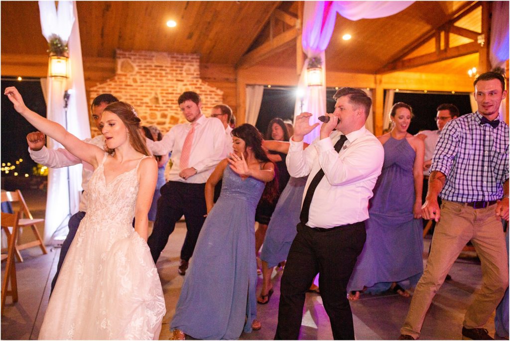 DJ leading a dance at wedding reception