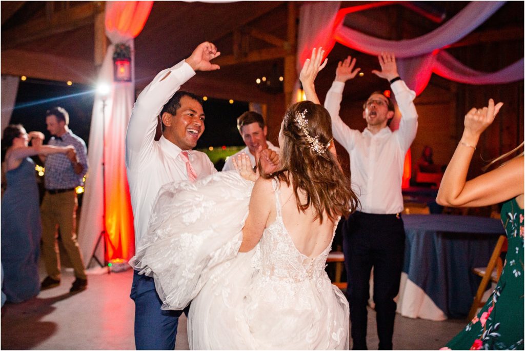 Bride dancing with husband and friends