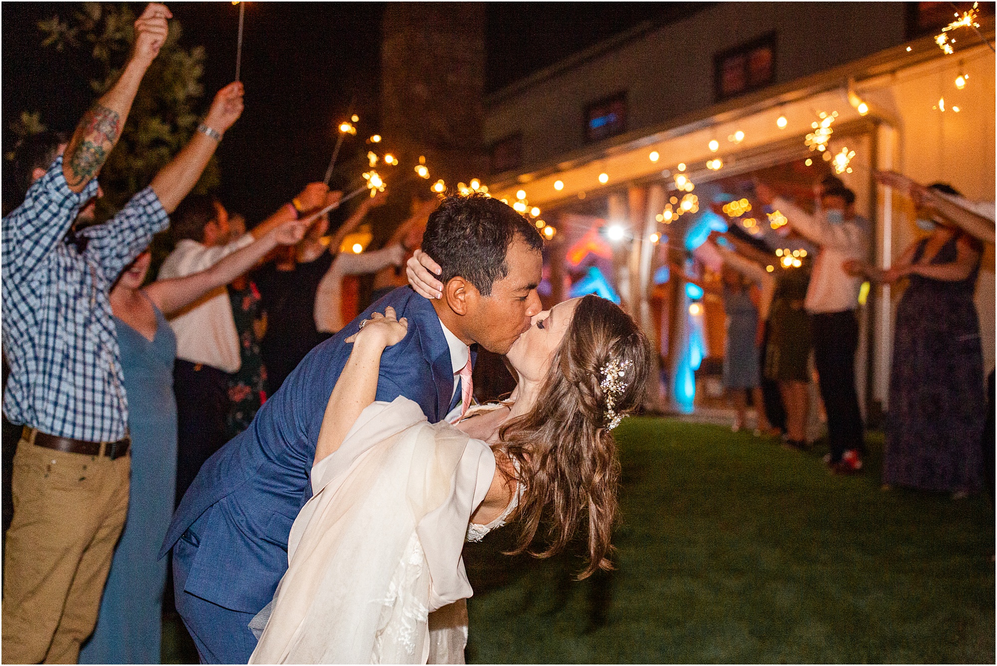 Just married couple leaving wedding under sparklers