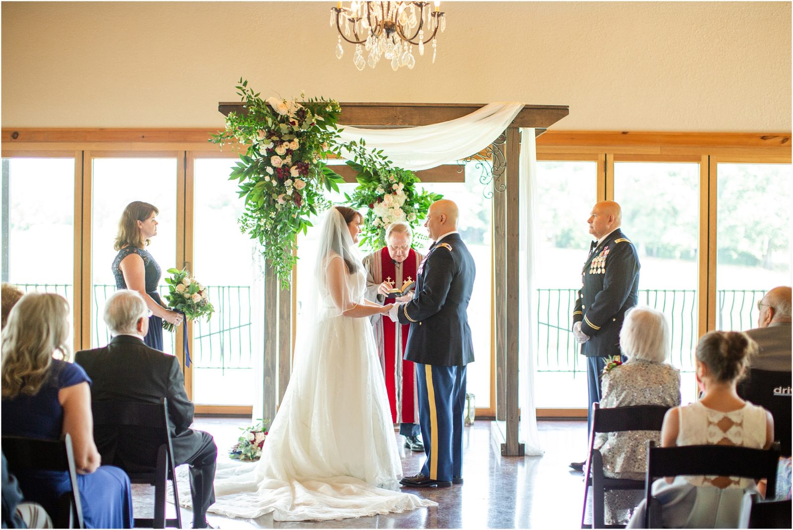 Couple standing in front of priest during wedding