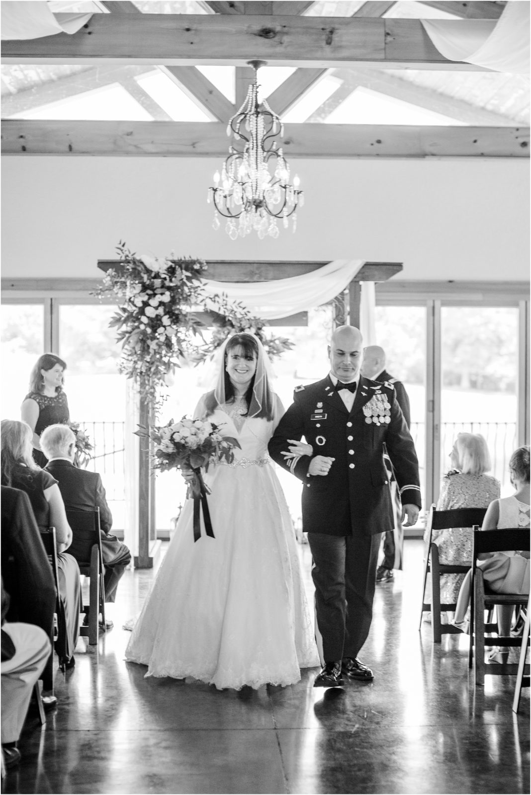 Military husband and bride walking down aisle