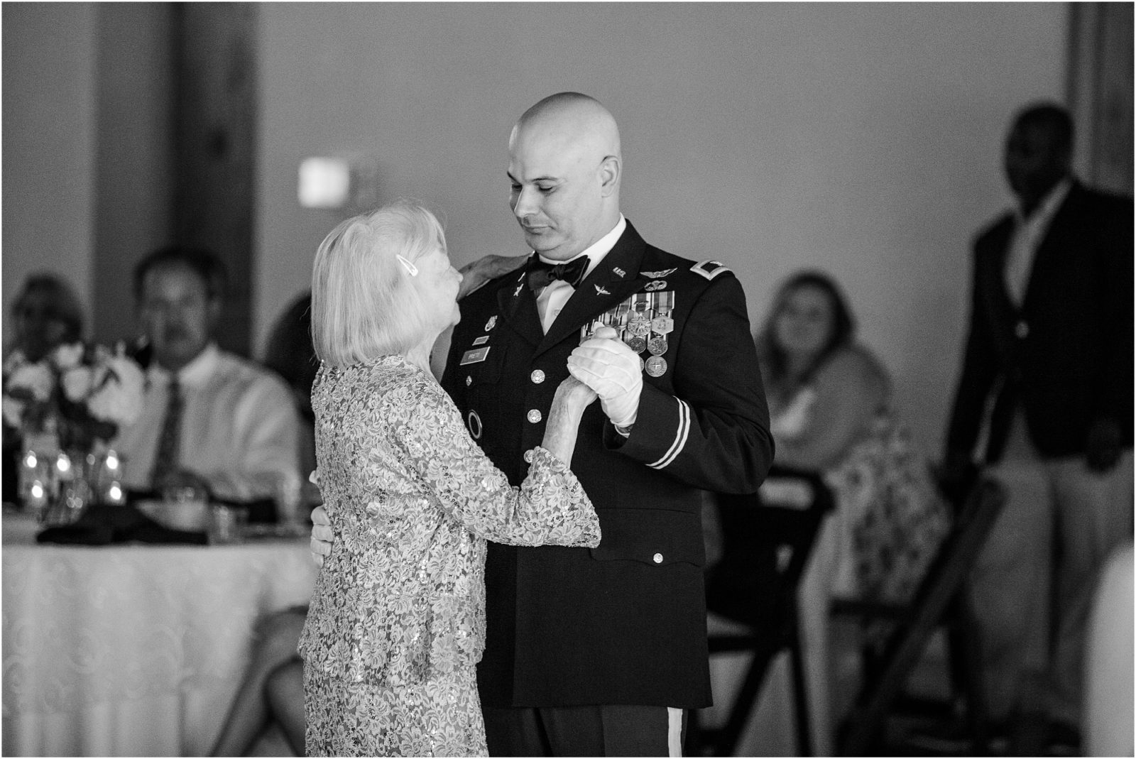 Military groom dancing with his mother