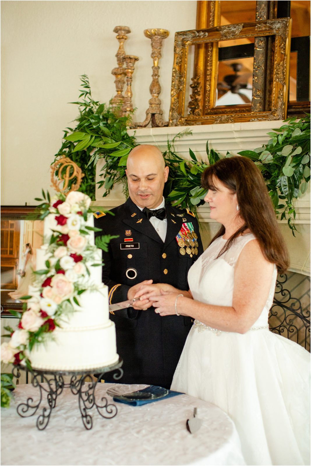 Military couple cutting wedding cake