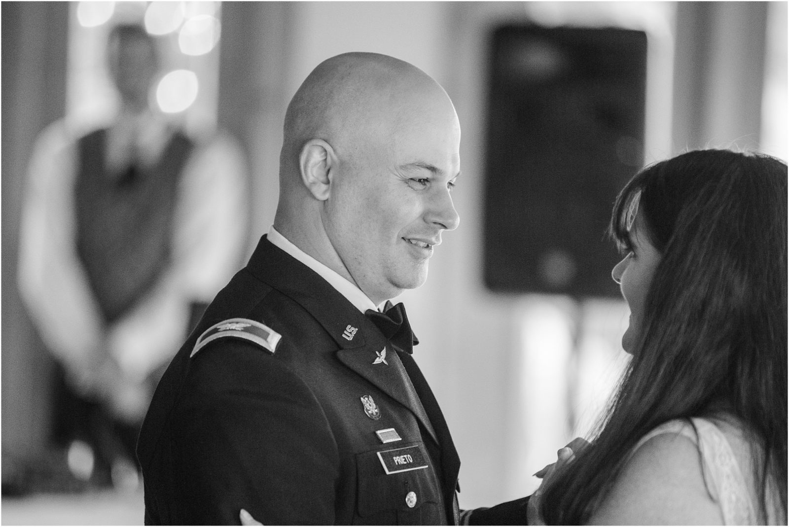 Military groom smiling at bride