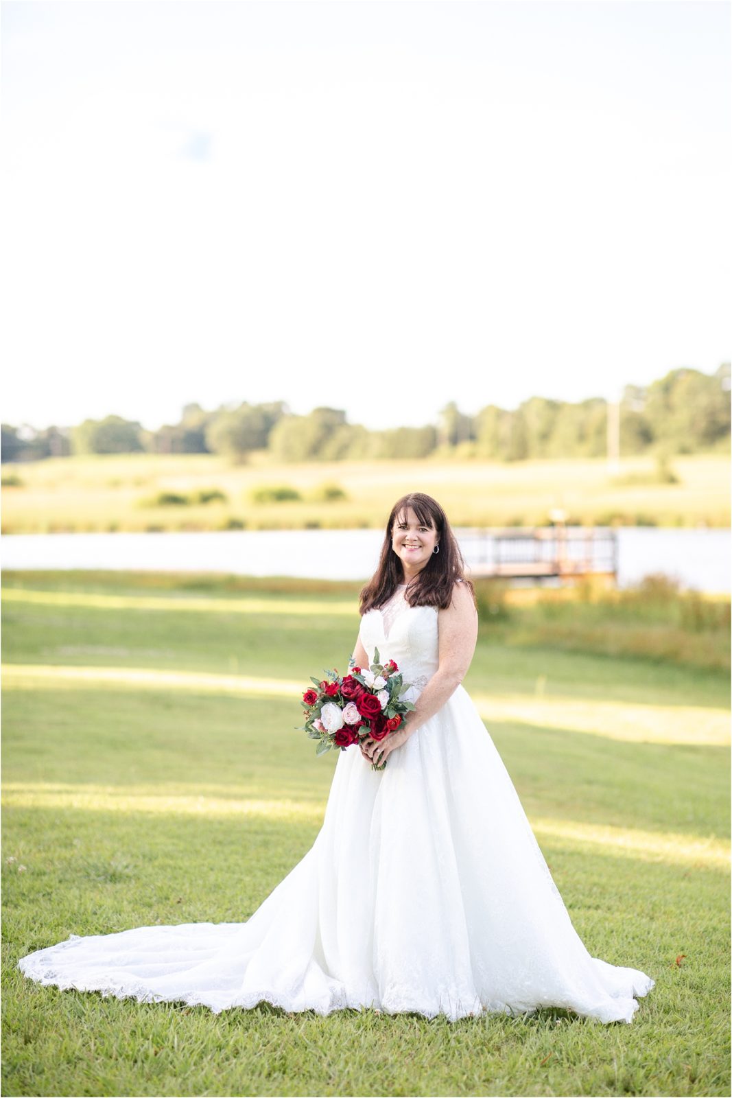 Bride in wedding dress holding red flowers